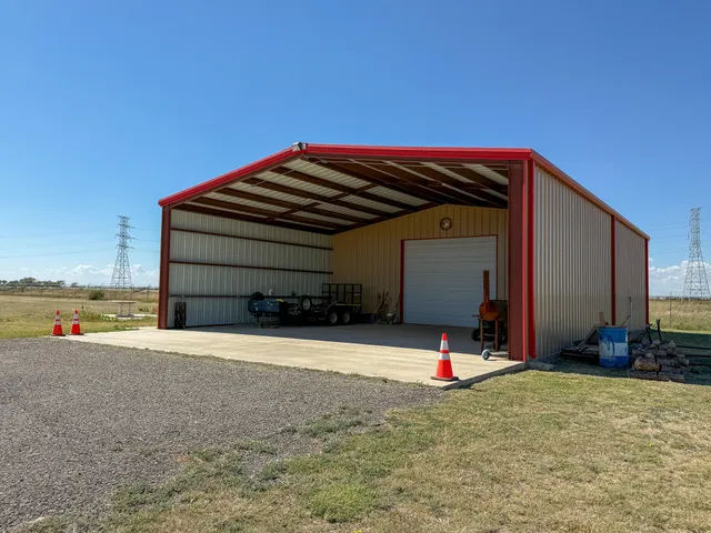 a large kitchen with granite countertop a stove a sink dishwasher and a refrigerator