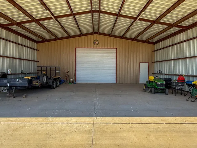 a large kitchen with granite countertop a sink a large oven a stove and a refrigerator