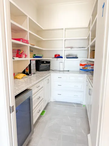 a bathroom with a granite countertop sink a mirror and shower
