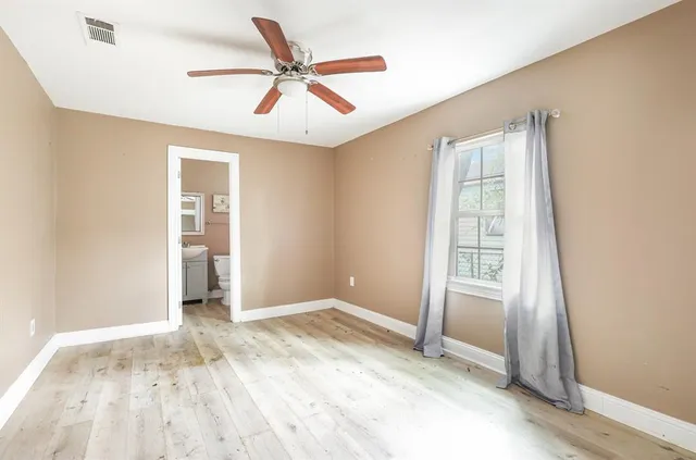 an empty room with windows and closet