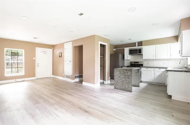 a view of a kitchen with a sink and a window