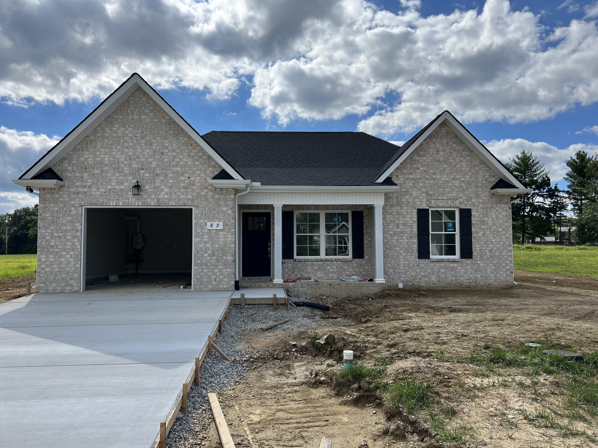 a front view of a house with a garden and yard