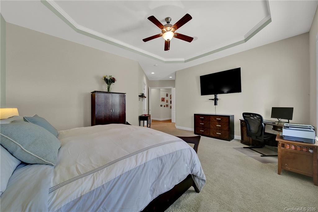 746 Quicksilver Trail Fort Mill, SC 29708 - Photo 15 of 35 a bedroom with a bed a flat screen tv and a chandelier
