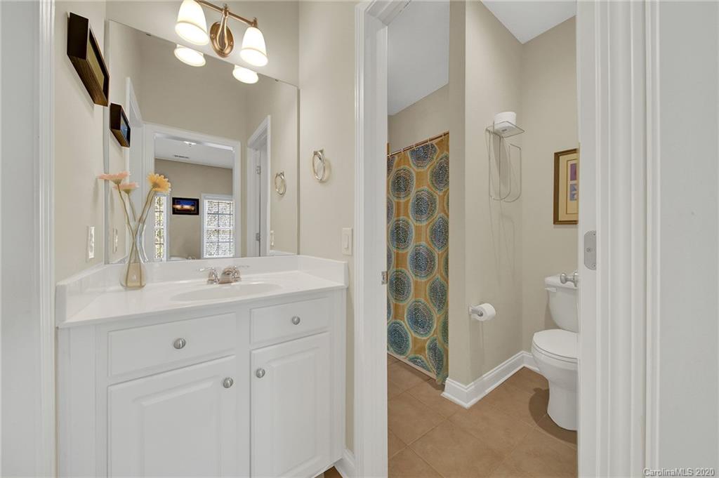 746 Quicksilver Trail Fort Mill, SC 29708 - Photo 23 of 35 a bathroom with a granite countertop sink a toilet and a mirror