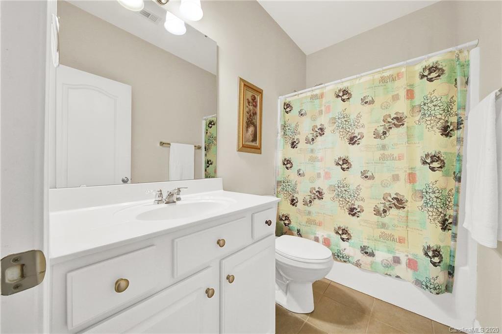 746 Quicksilver Trail Fort Mill, SC 29708 - Photo 29 of 35 a bathroom with a sink a toilet a shower curtain and a mirror