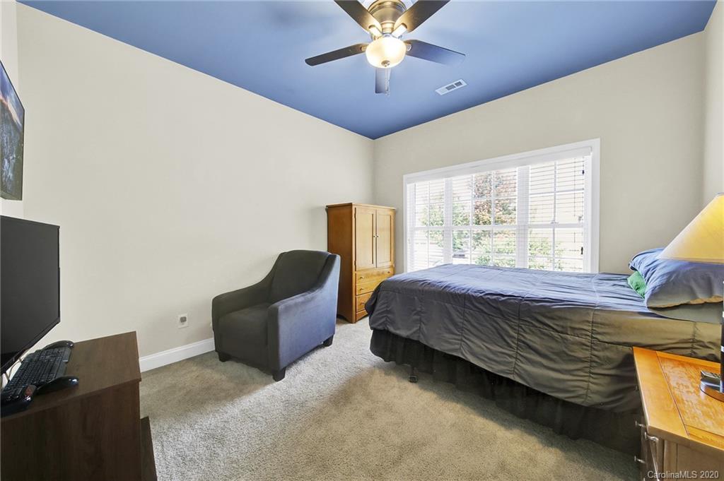 746 Quicksilver Trail Fort Mill, SC 29708 - Photo 30 of 35 a bedroom with a bed and a chandelier