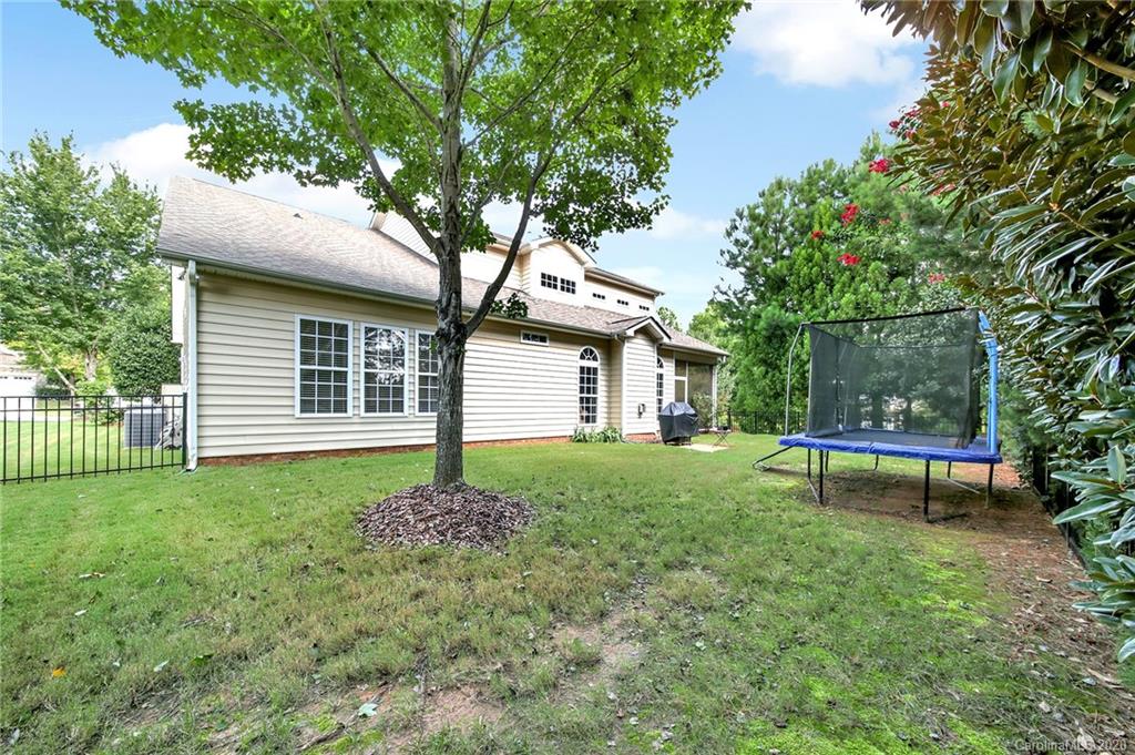 746 Quicksilver Trail Fort Mill, SC 29708 - Photo 34 of 35 a view of a backyard with table and chairs and a large tree