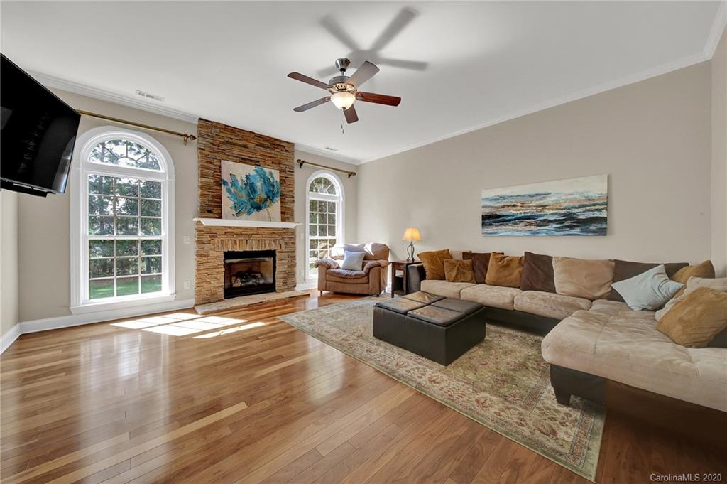 746 Quicksilver Trail Fort Mill, SC 29708 - Photo 7 of 35 a living room with furniture a fireplace and a flat screen tv