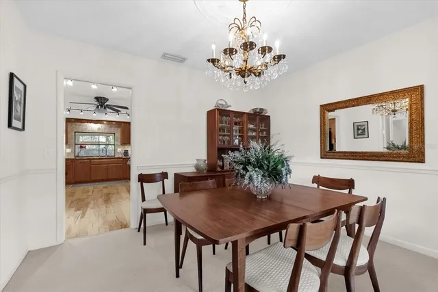 a view of a dining room with furniture and chandelier