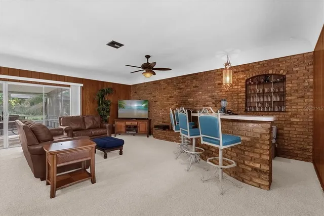 a living room with furniture and a ceiling fan