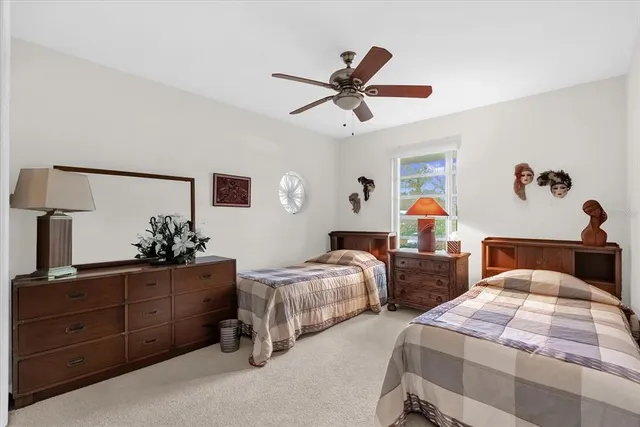 a bedroom with two beds and a dresser