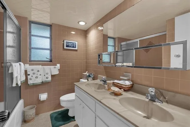 a bathroom with a sink mirror and toilet