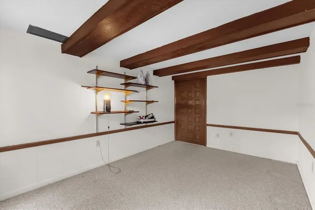 a large white kitchen with a sink and a refrigerator