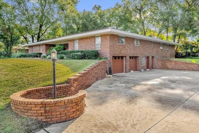 a house with swimming pool in front of it