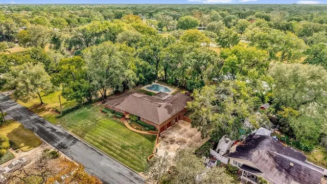 an aerial view of a house with a yard