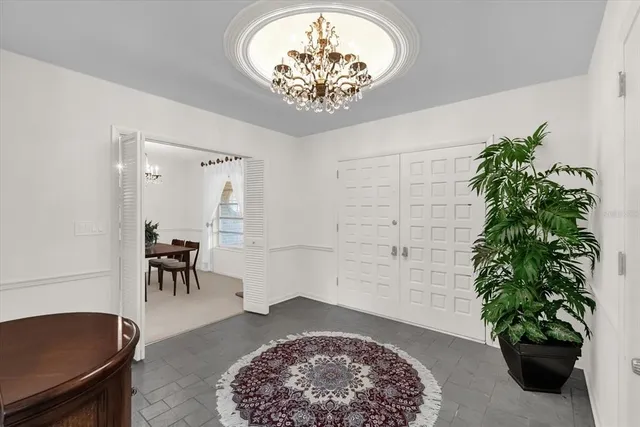 a view of a hallway with furniture and a potted plant