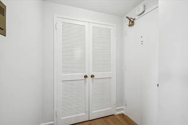 a view of a room with wooden floor