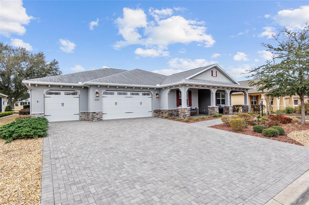 8749 Southwest 93rd Circle Ocala, FL 34481 - Photo 1 of 1 a front view of a house with a yard and garage