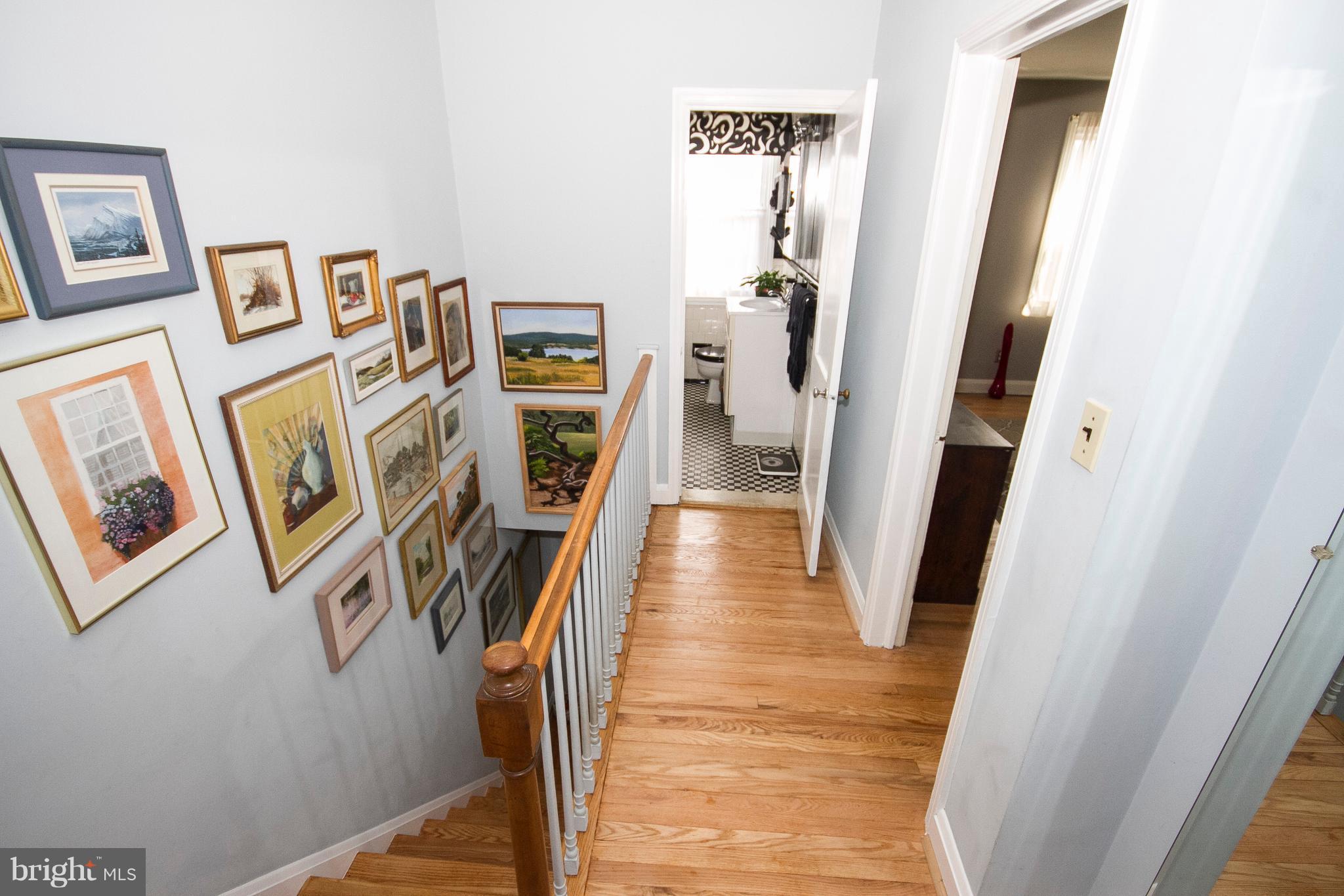 1809 Glen Ridge Road Towson, MD 21286 - Photo 12 of 30 a view of a hallway with paintings on the wall