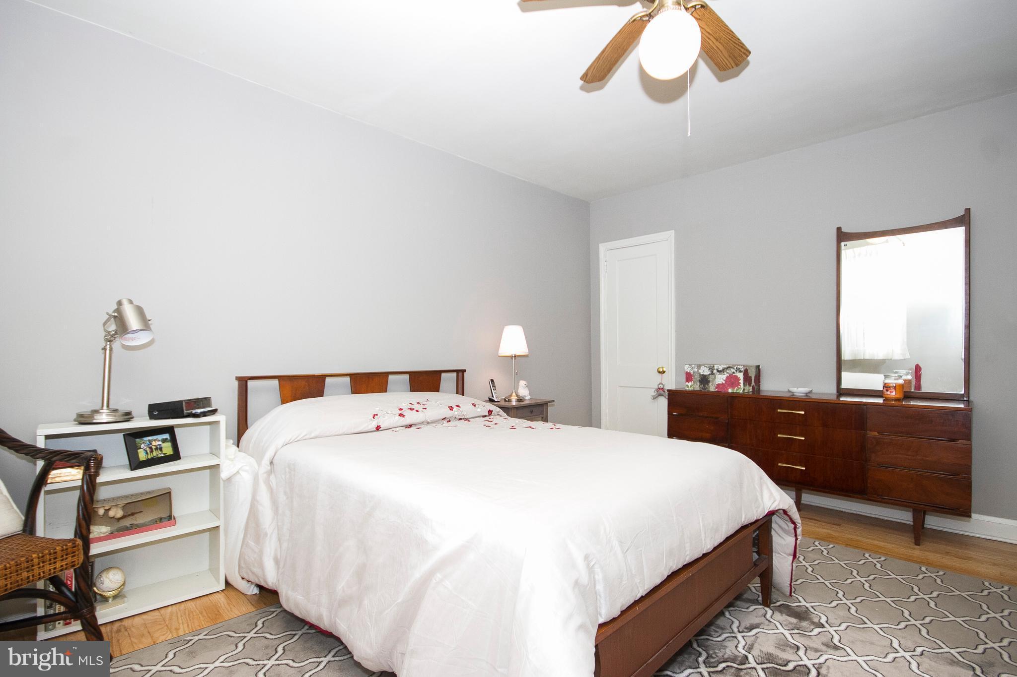 1809 Glen Ridge Road Towson, MD 21286 - Photo 14 of 30 a bedroom with a bed and a chandelier