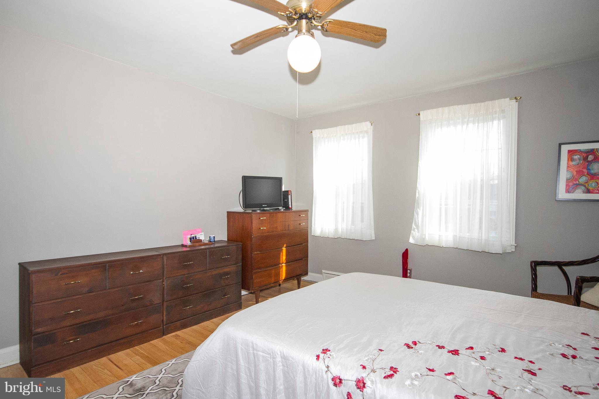 1809 Glen Ridge Road Towson, MD 21286 - Photo 15 of 30 a bedroom with a bed and a chandelier