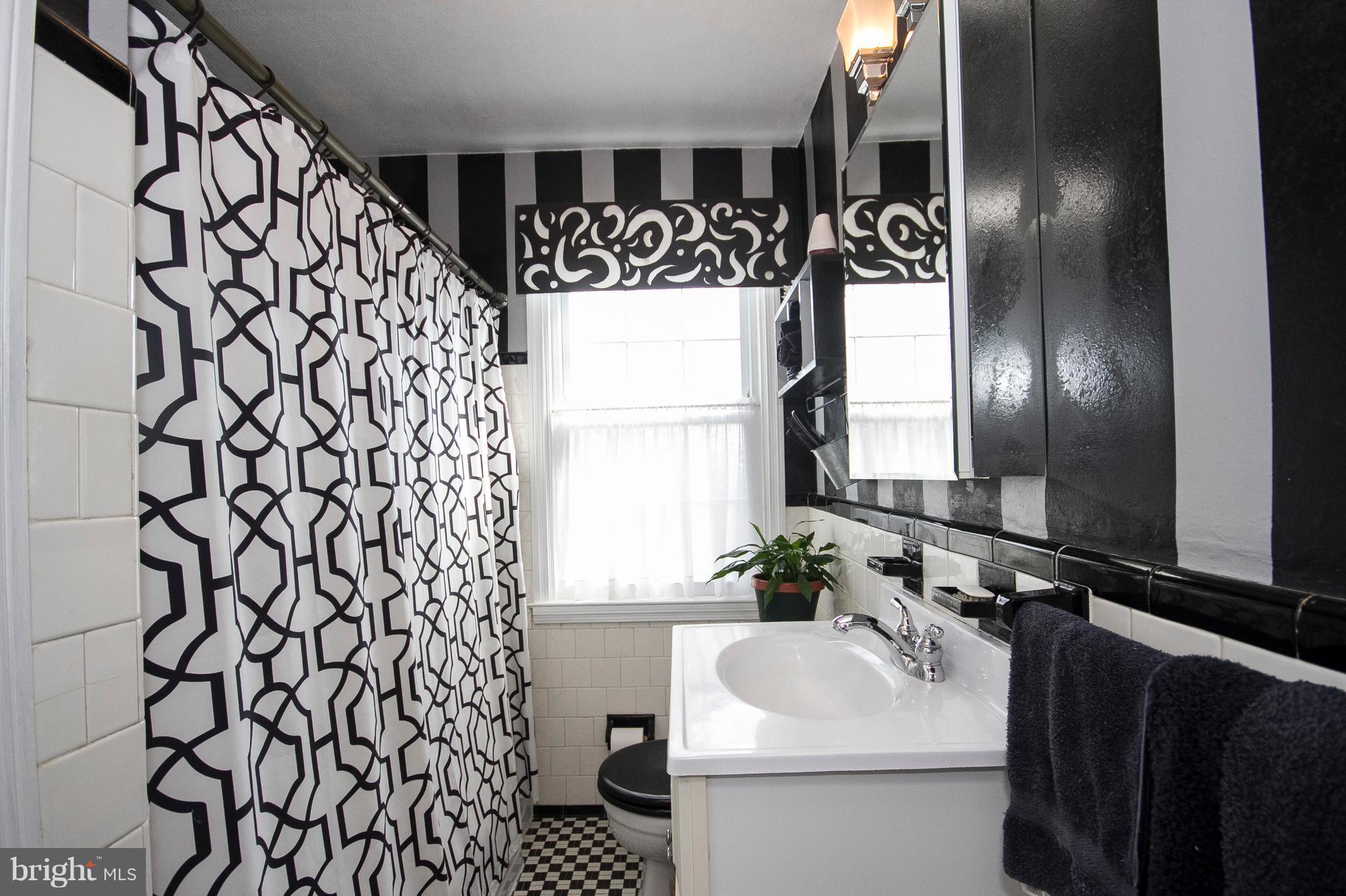 1809 Glen Ridge Road Towson, MD 21286 - Photo 18 of 30 a bathroom with a sink and mirror with toilet