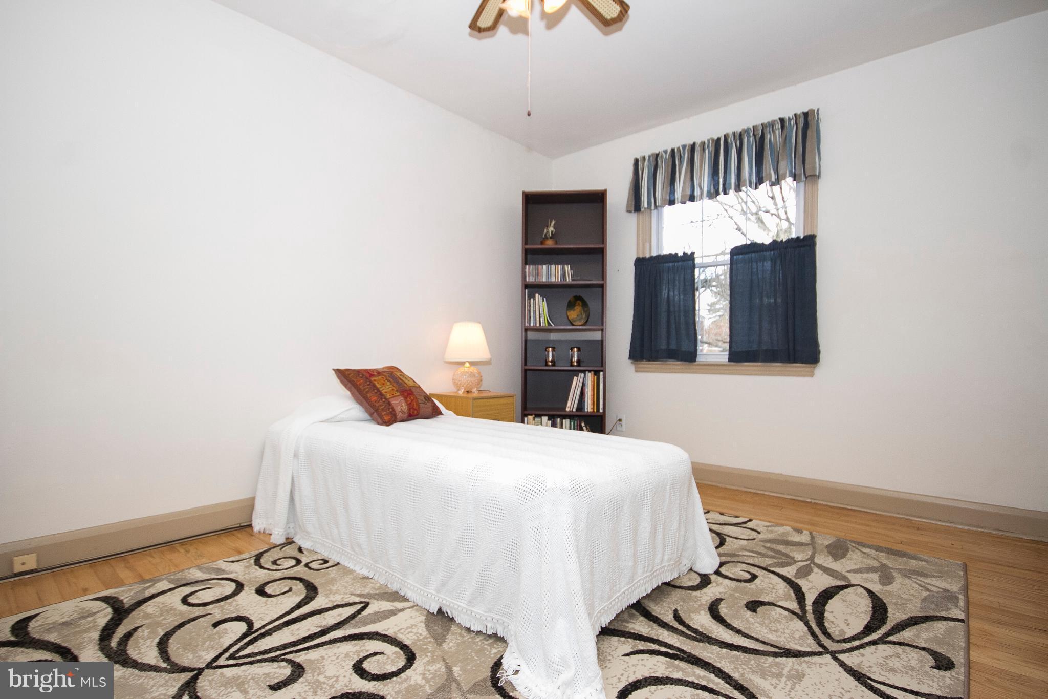 1809 Glen Ridge Road Towson, MD 21286 - Photo 21 of 30 a bedroom with a bed and dresser with mirror