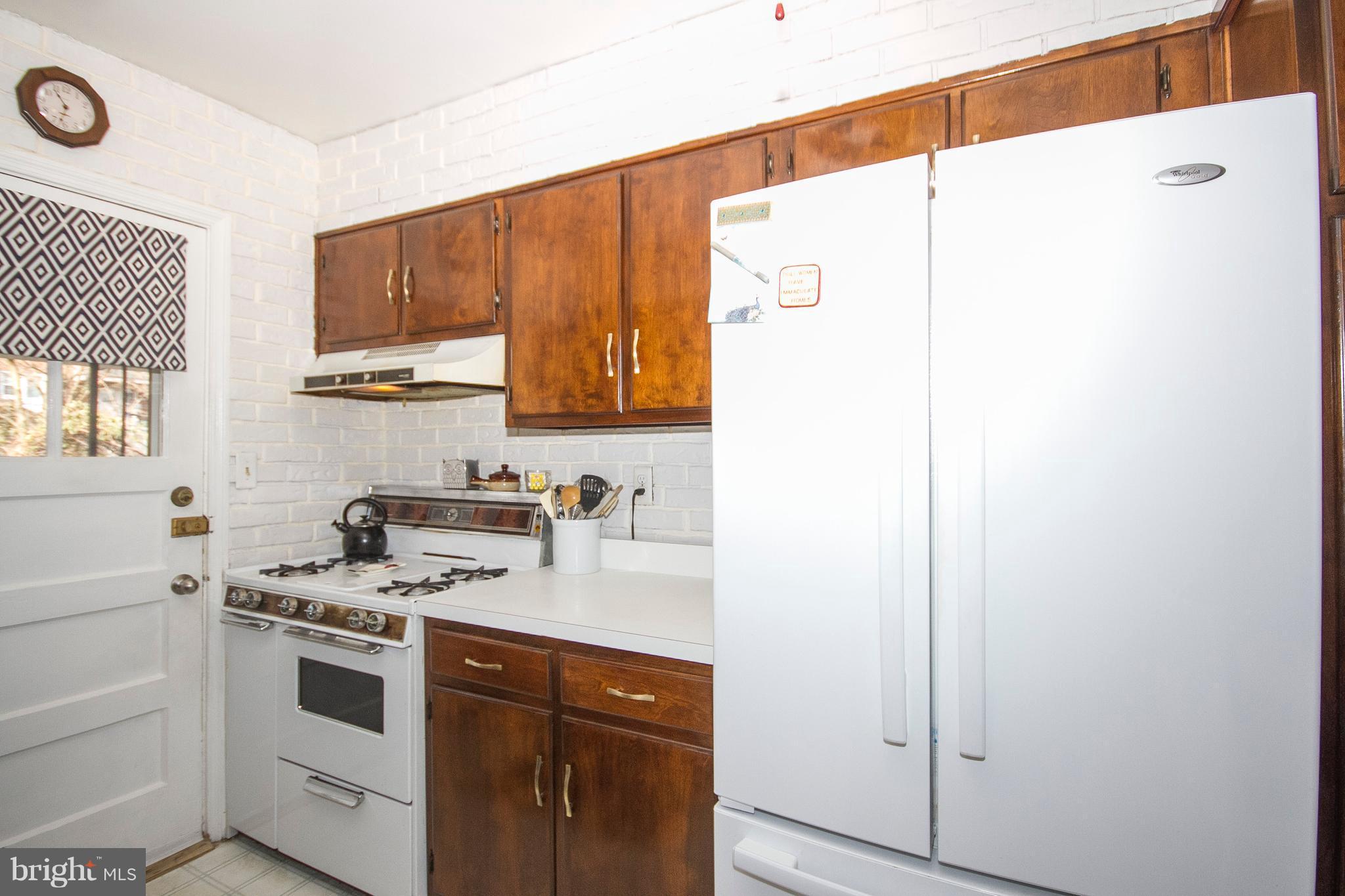 1809 Glen Ridge Road Towson, MD 21286 - Photo 8 of 30 a kitchen with a white cabinets and white appliances