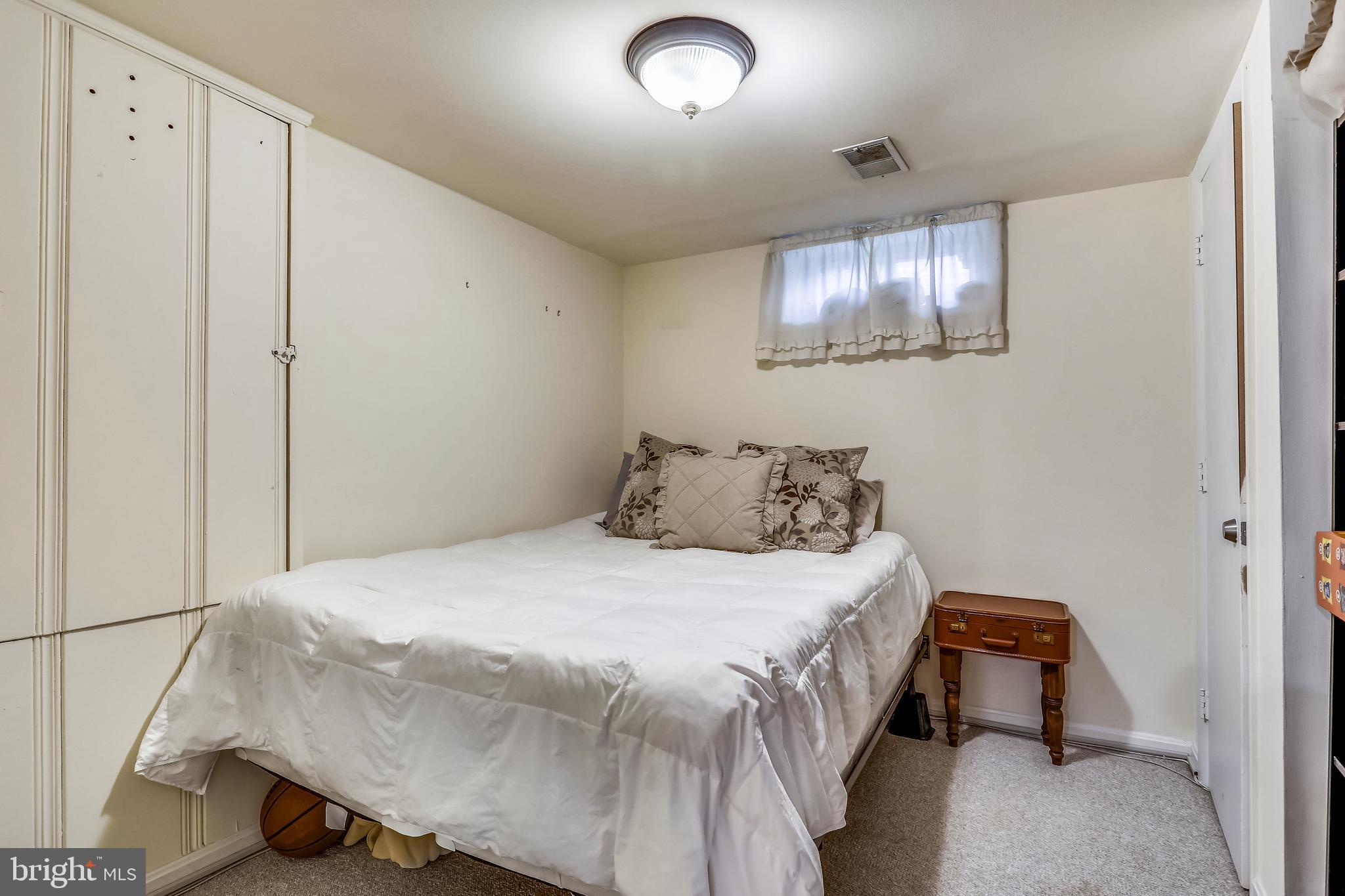4319 Fernhill Road Silver Spring, MD 20906 - Photo 18 of 29 a bedroom with a bed and a night stand