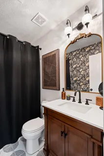 a backyard of a house with barbeque oven table and chairs