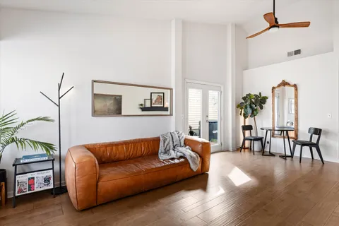 a living room with furniture and a wooden floor