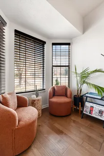 a bedroom with bed couch and window