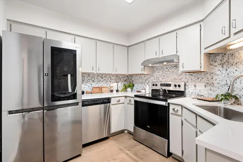 a kitchen with a sink cabinets and appliances