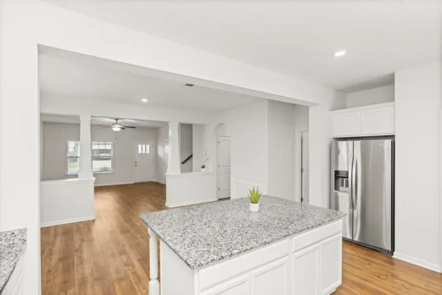a kitchen with stainless steel appliances granite countertop a stove and a refrigerator