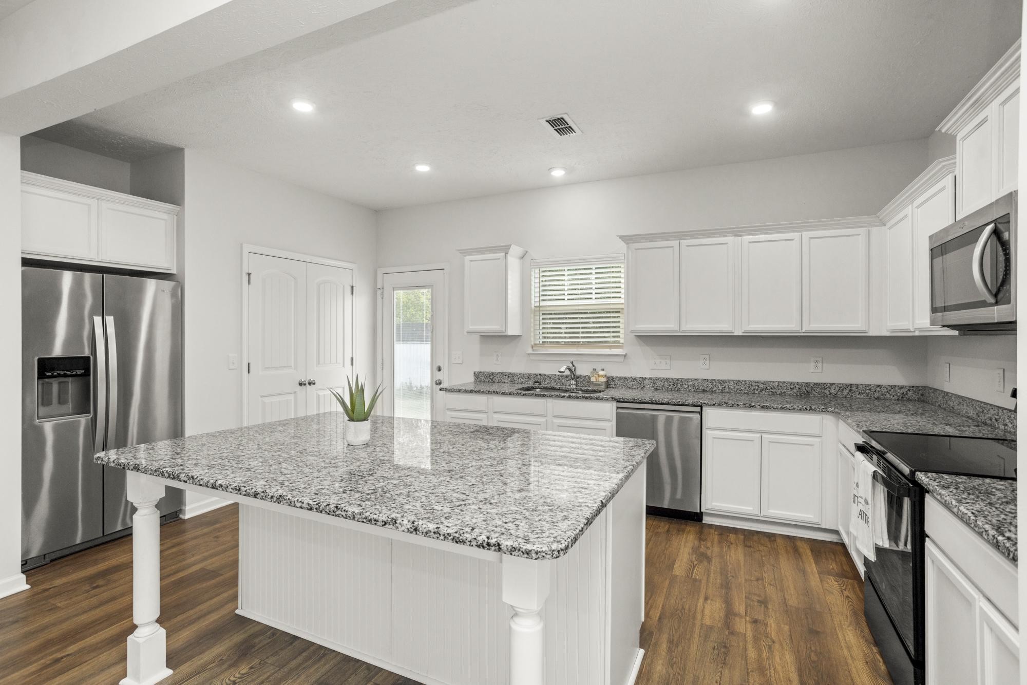 1832 Charismatic Place Murfreesboro, TN 37128 - Photo 16 of 45 a kitchen with kitchen island granite countertop a stove sink and refrigerator