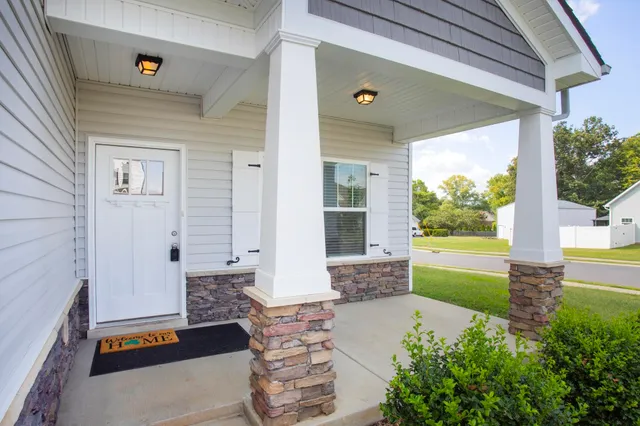 a front view of a house with a garden