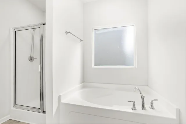 a white bath tub sitting next to a shower
