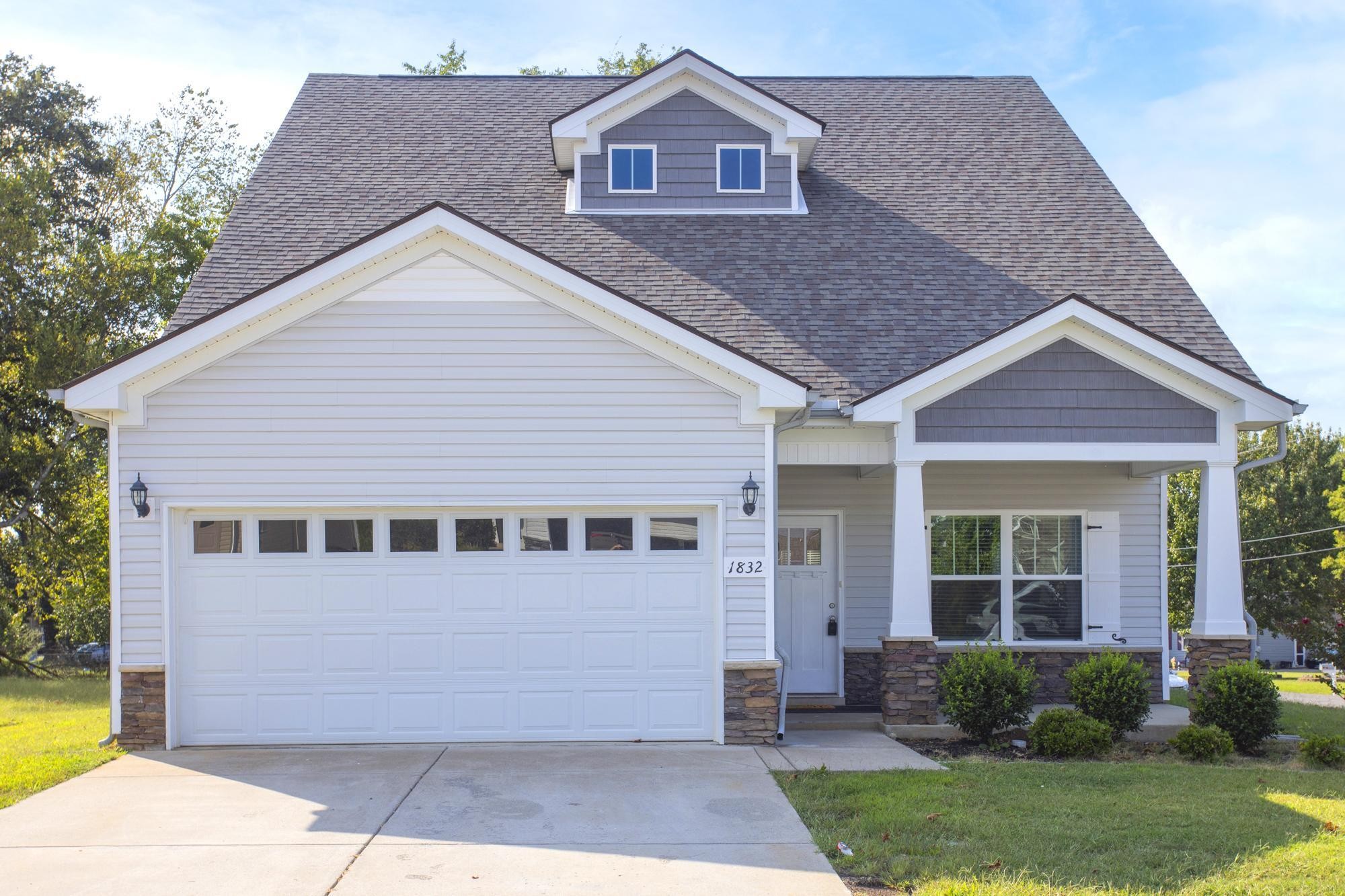 1832 Charismatic Place Murfreesboro, TN 37128 - Photo 44 of 45 a view of a yard in front of a house with plants and large tree