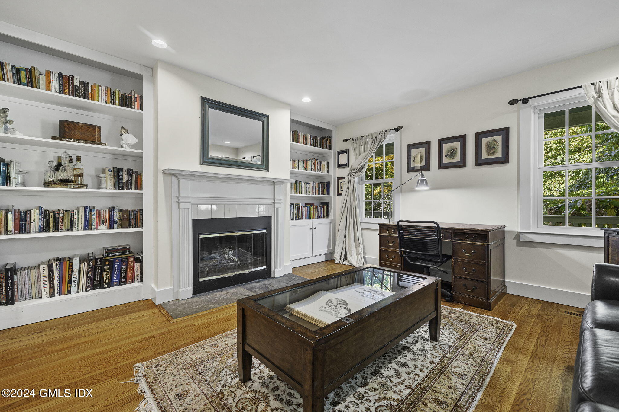 69 Riverside Avenue Riverside, CT 06878 - Photo 11 of 33 a living room with furniture a rug and a book shelf