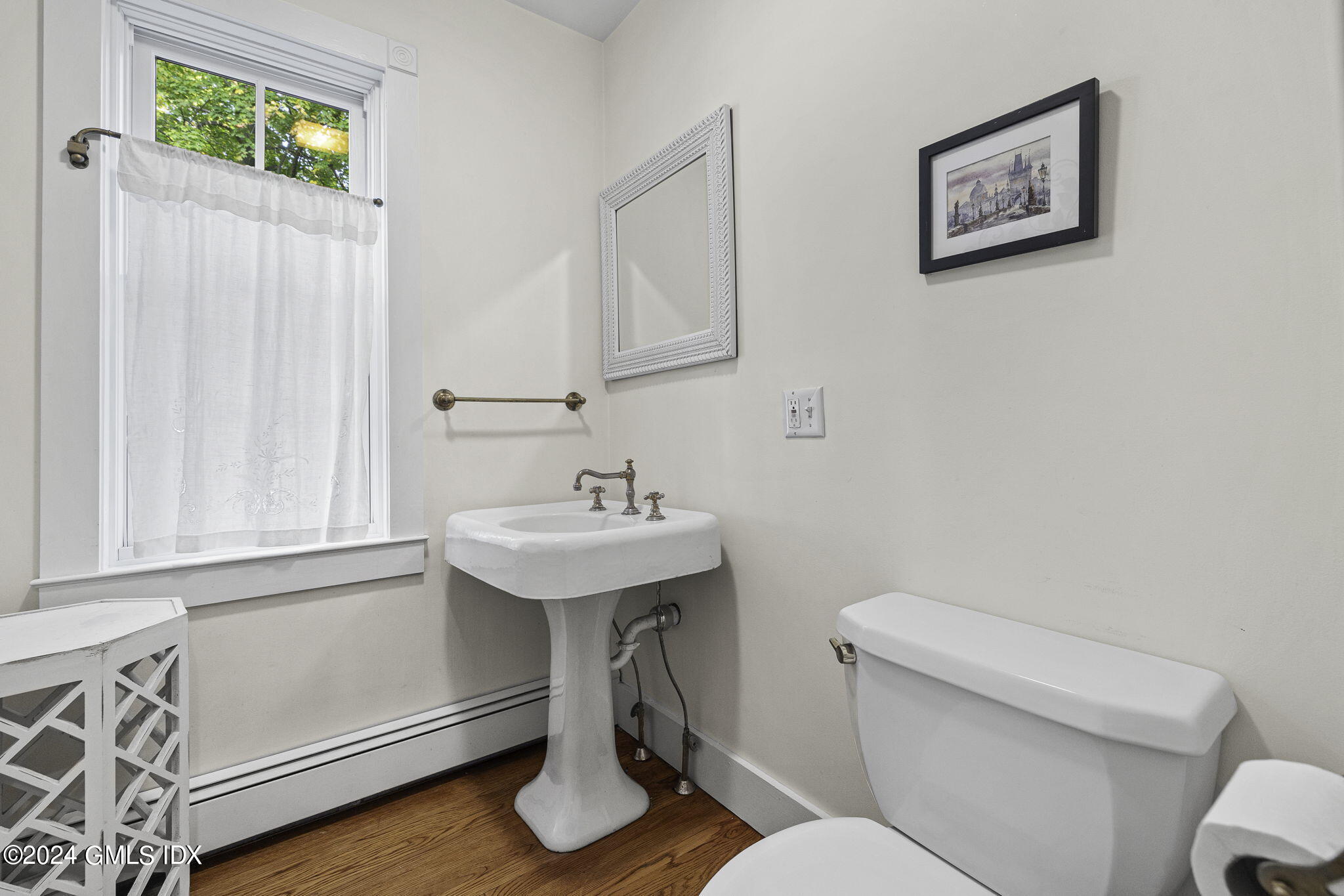 69 Riverside Avenue Riverside, CT 06878 - Photo 12 of 33 a bathroom with a toilet a sink and a window