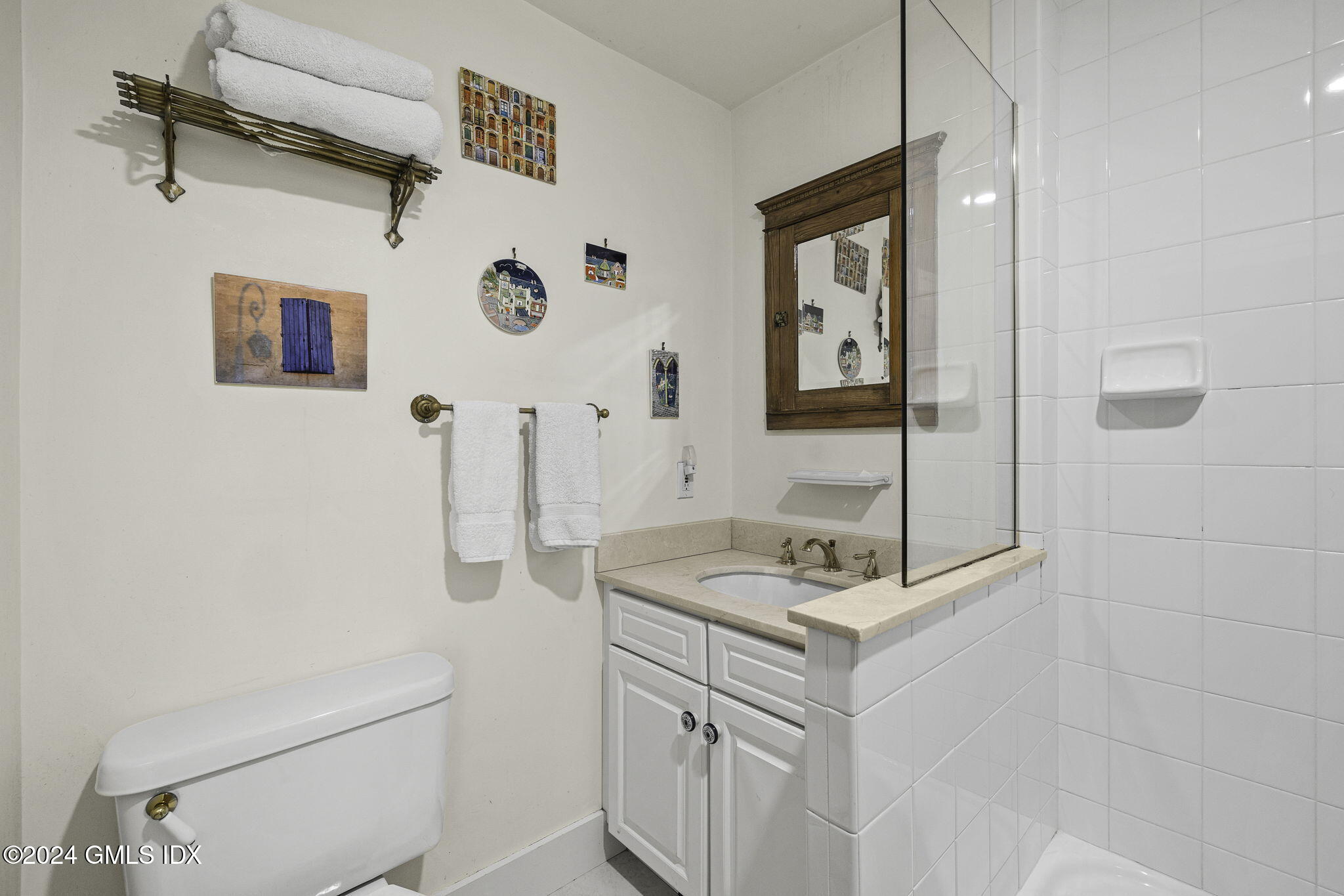 69 Riverside Avenue Riverside, CT 06878 - Photo 20 of 33 a bathroom with a sink vanity and a mirror