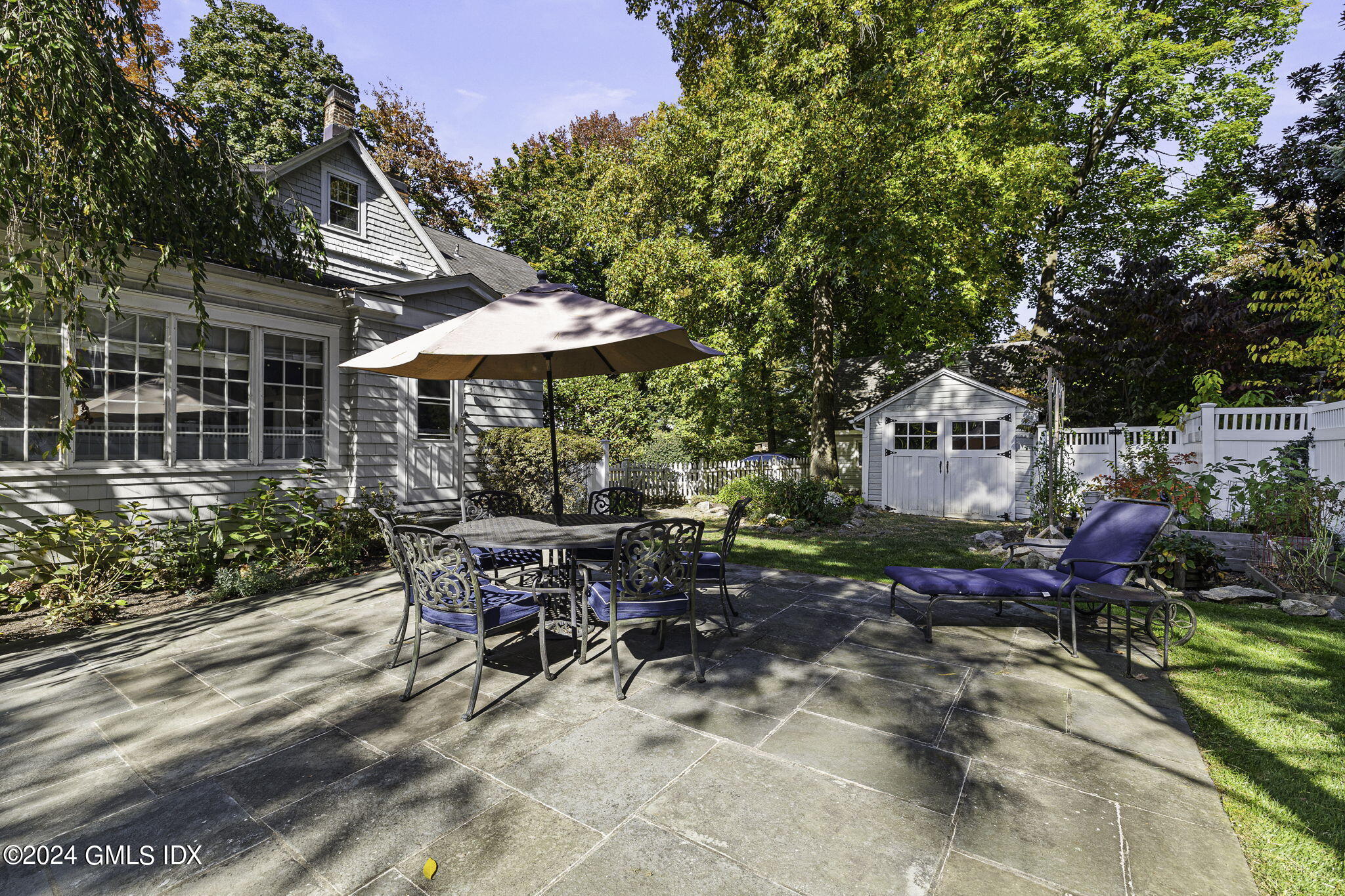 69 Riverside Avenue Riverside, CT 06878 - Photo 25 of 33 a view of a patio with table and chairs and potted plants