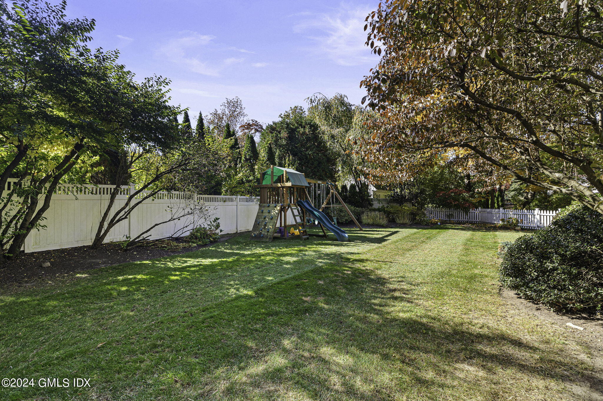 69 Riverside Avenue Riverside, CT 06878 - Photo 27 of 33 a backyard of a house with lots of green space and lake view
