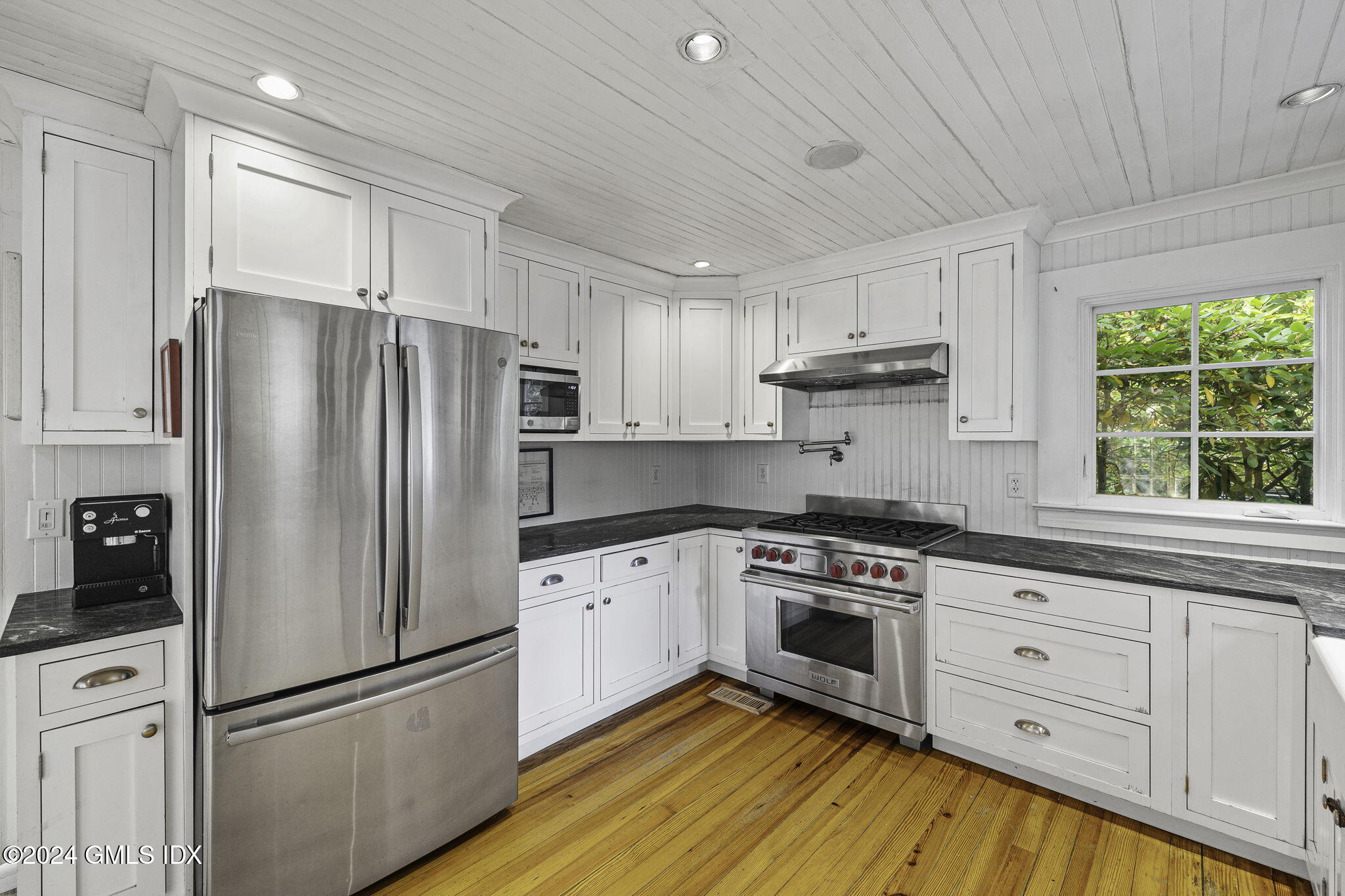 69 Riverside Avenue Riverside, CT 06878 - Photo 8 of 33 a kitchen with granite countertop white cabinets and stainless steel appliances