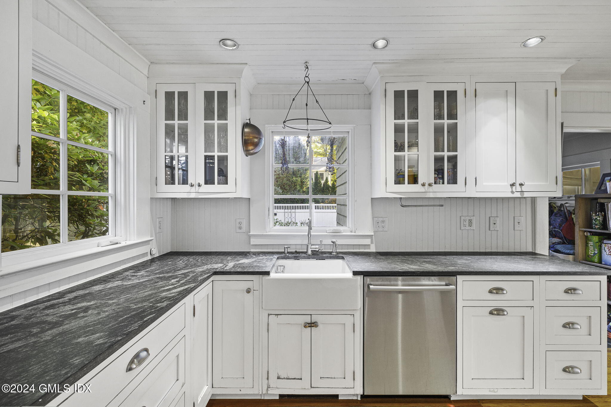 69 Riverside Avenue Riverside, CT 06878 - Photo 9 of 33 a kitchen with granite countertop white cabinets and window