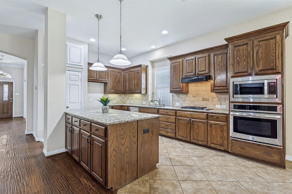 1803 Caprock Road Allen, TX 75002 - Photo 4 of 32 Large stroage island in the kitchen