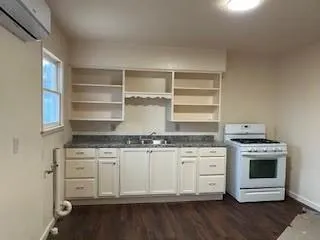 a kitchen with stainless steel appliances granite countertop a stove and white cabinets