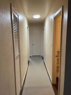 a view of a hallway with stairs