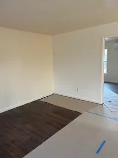 an empty room with wooden floor
