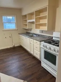 a kitchen with granite countertop a stove and a sink